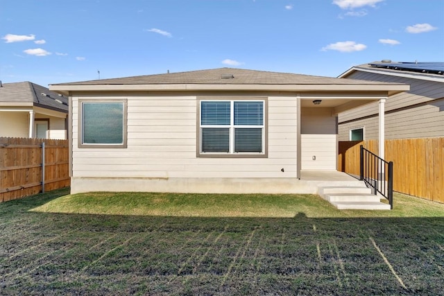 rear view of house with a yard