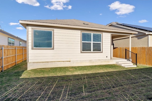 back of house featuring a yard