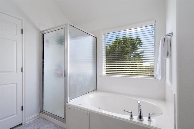 bathroom featuring lofted ceiling and shower with separate bathtub