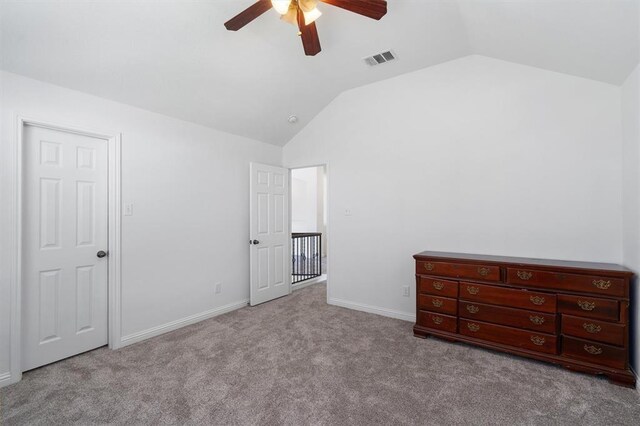 unfurnished bedroom with light colored carpet, ceiling fan, and lofted ceiling