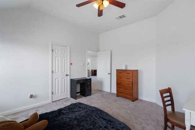 carpeted bedroom featuring vaulted ceiling and ceiling fan