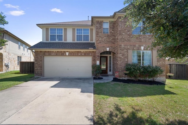 traditional-style house featuring concrete driveway, brick siding, fence, and a front lawn