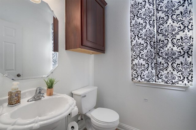 bathroom with toilet and sink