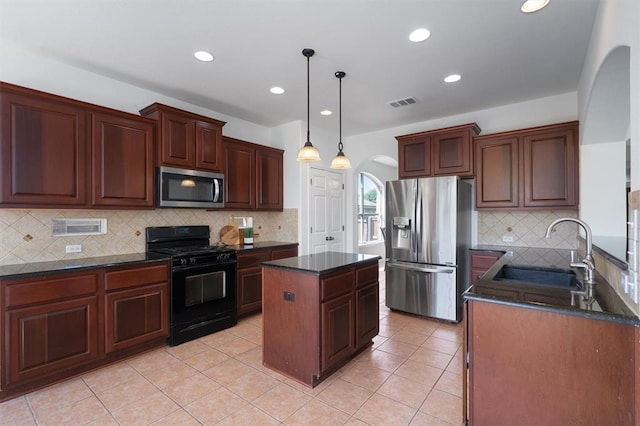 kitchen with a center island, backsplash, sink, hanging light fixtures, and stainless steel appliances