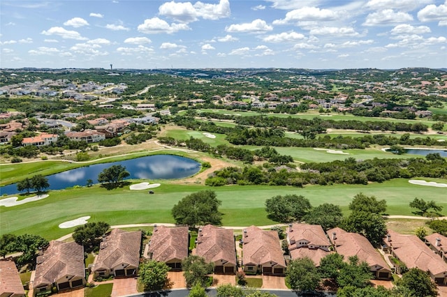 drone / aerial view with a residential view, a water view, and golf course view