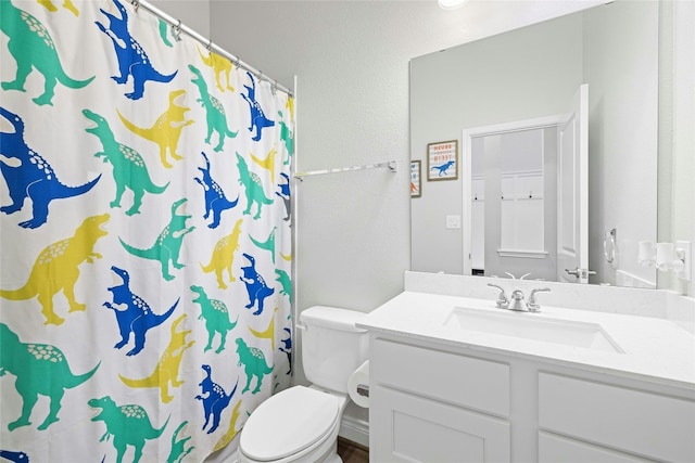 bathroom with vanity, a shower with curtain, and toilet