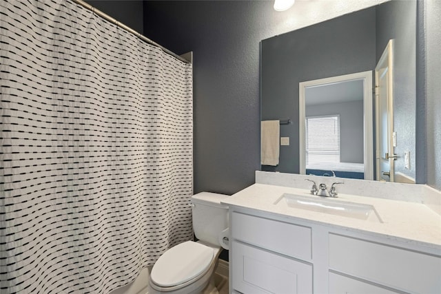 bathroom featuring vanity, toilet, and curtained shower