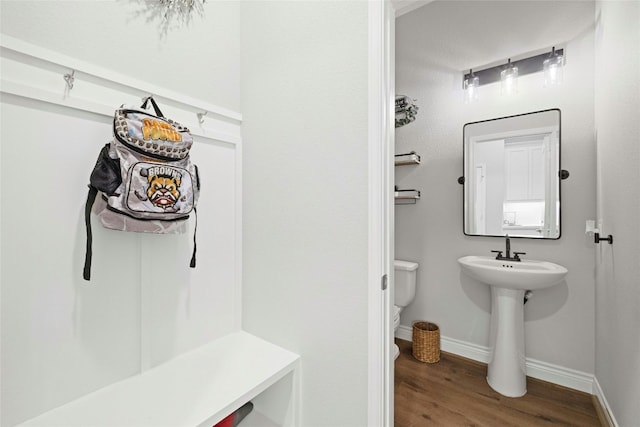 bathroom featuring sink, hardwood / wood-style flooring, and toilet