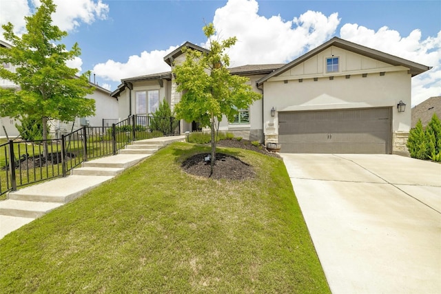 view of front of property with a front yard and a garage