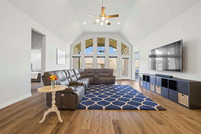 living room featuring wood-type flooring, vaulted ceiling, and ceiling fan