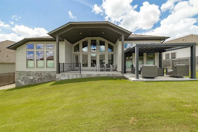 back of property with an outdoor living space, a lawn, and a patio