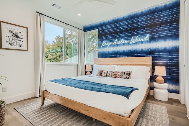 bedroom featuring hardwood / wood-style flooring and ceiling fan