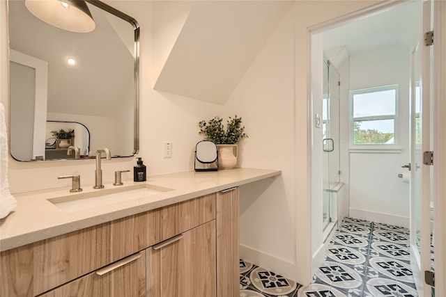 bathroom featuring tile patterned flooring, vanity, and a shower with shower door