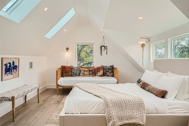 bedroom with light wood-type flooring and vaulted ceiling