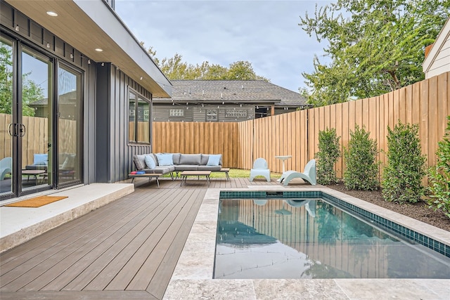 view of swimming pool featuring an outdoor living space and a deck