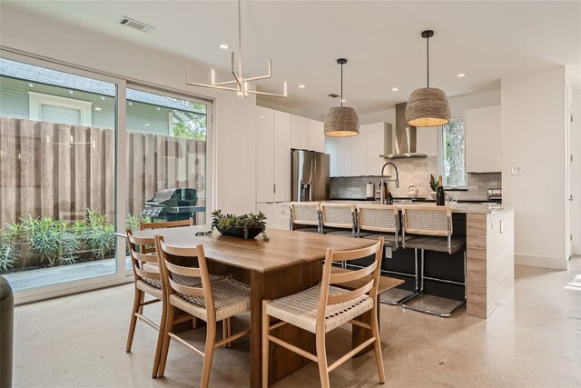 dining space featuring plenty of natural light and an inviting chandelier