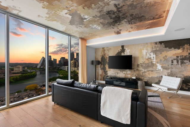 living room featuring expansive windows and light hardwood / wood-style floors