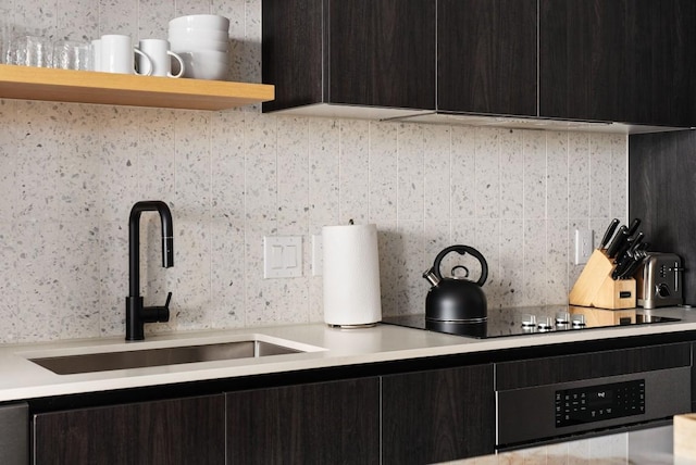 kitchen featuring tasteful backsplash, sink, and wall oven