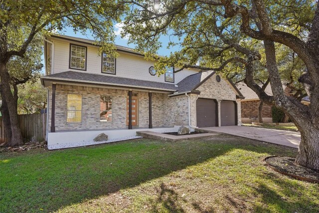 view of front facade featuring covered porch, a garage, and a front lawn