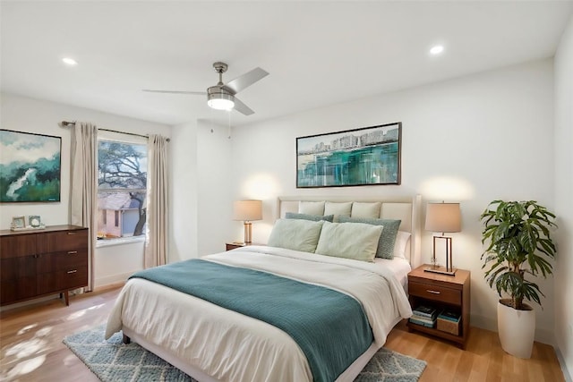 bedroom with ceiling fan and light wood-type flooring