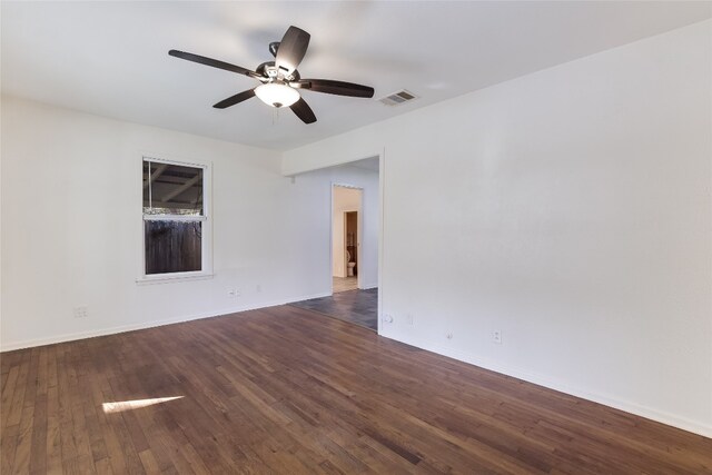 spare room with dark hardwood / wood-style floors and ceiling fan