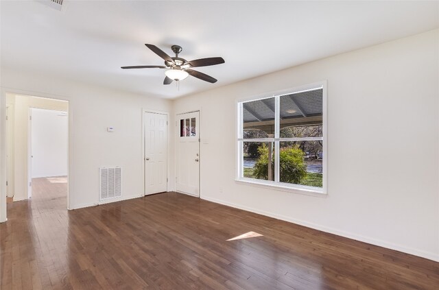 spare room featuring dark hardwood / wood-style flooring and ceiling fan