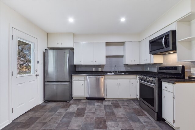 kitchen featuring white cabinets, decorative backsplash, sink, and stainless steel appliances