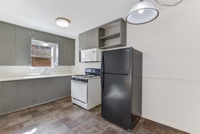 kitchen with gray cabinetry, sink, and white appliances