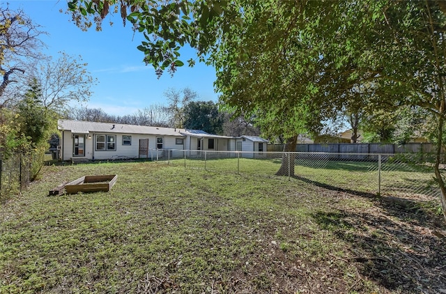 rear view of property featuring a lawn