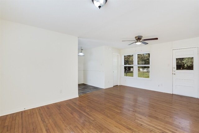 empty room featuring dark hardwood / wood-style floors and ceiling fan