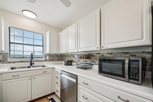 kitchen featuring tasteful backsplash, white cabinetry, sink, and stainless steel appliances