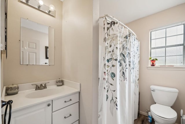 bathroom with a shower with shower curtain, vanity, toilet, and hardwood / wood-style floors