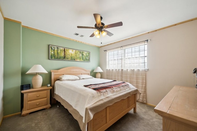 carpeted bedroom with ceiling fan and ornamental molding