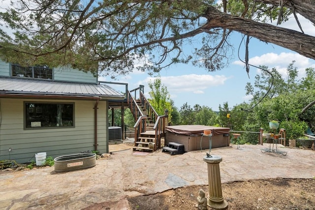 view of patio with central AC and a hot tub