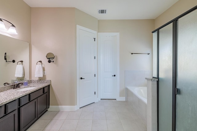 bathroom with tile patterned floors, separate shower and tub, and vanity