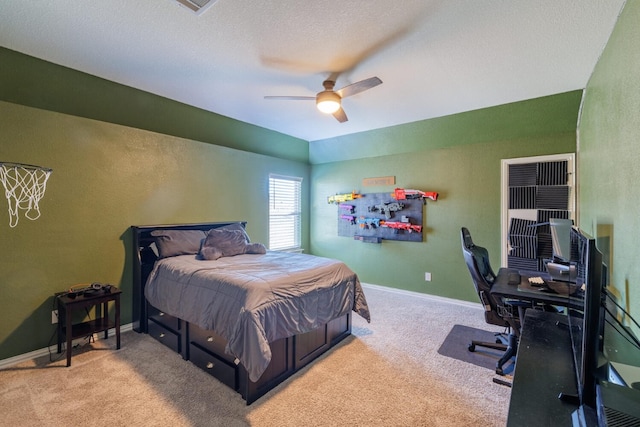 carpeted bedroom featuring ceiling fan and a textured ceiling