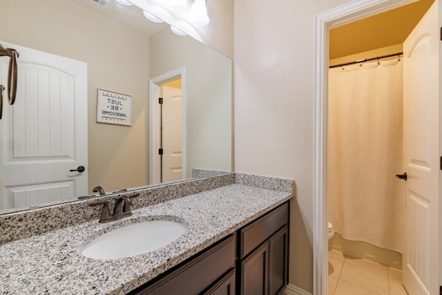 bathroom with tile patterned floors, a shower with curtain, vanity, and toilet