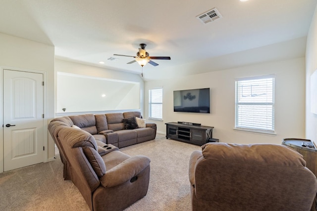 carpeted living room with ceiling fan and a healthy amount of sunlight