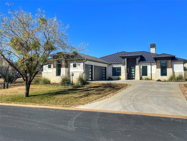 view of front of house featuring a garage and a front lawn