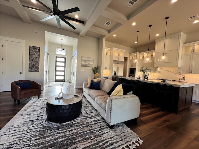 living room featuring beamed ceiling, dark hardwood / wood-style floors, ceiling fan, and coffered ceiling