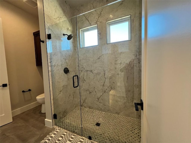 bathroom featuring tile patterned floors, toilet, and walk in shower