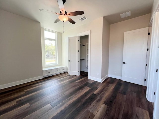 unfurnished bedroom with ceiling fan and dark hardwood / wood-style floors