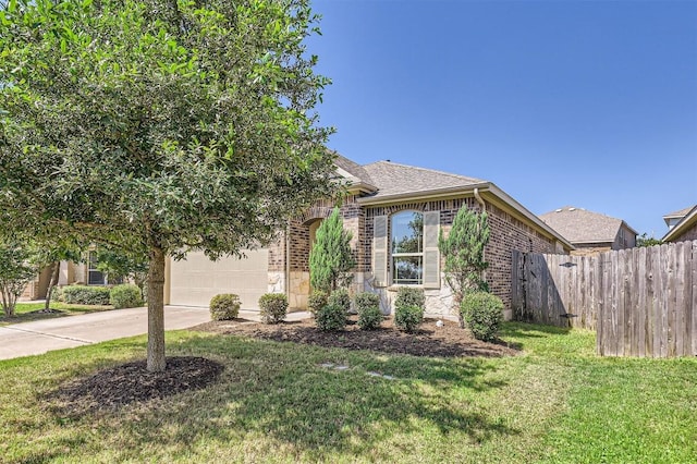 view of front of property featuring a garage and a front lawn