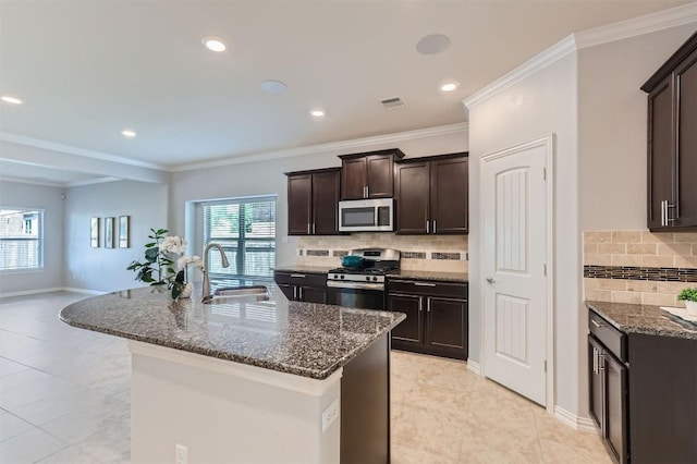 kitchen featuring backsplash, sink, dark brown cabinetry, and stainless steel appliances