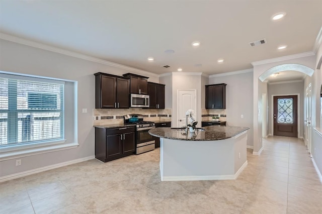 kitchen featuring sink, tasteful backsplash, dark stone counters, appliances with stainless steel finishes, and ornamental molding