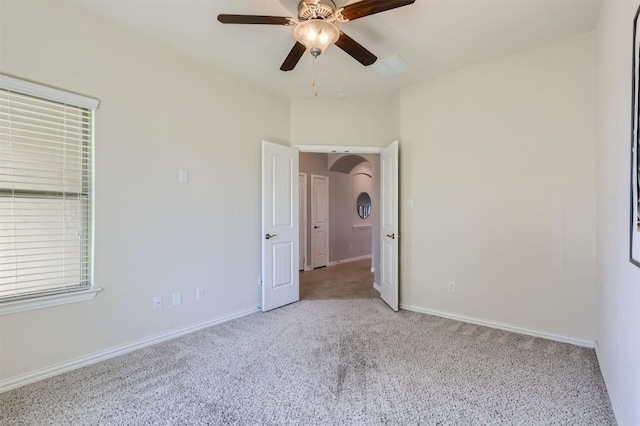 carpeted empty room featuring ceiling fan