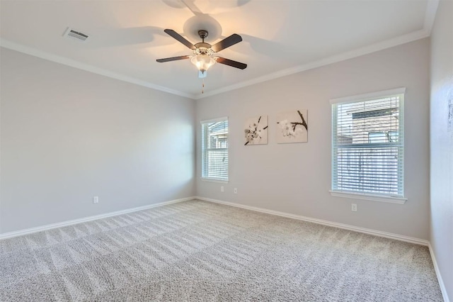 carpeted spare room featuring ceiling fan and ornamental molding