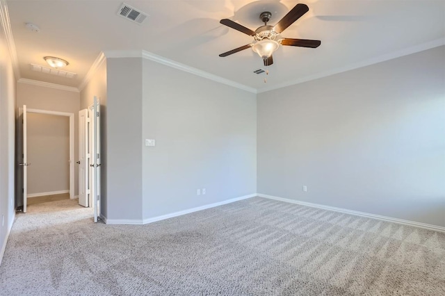 spare room featuring ceiling fan, light colored carpet, and ornamental molding