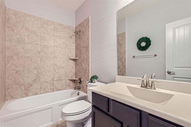 full bathroom featuring toilet, vanity, and tiled shower / bath