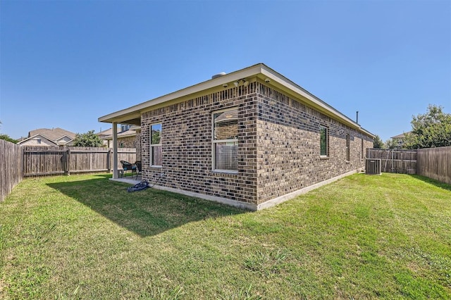 view of side of home with a yard